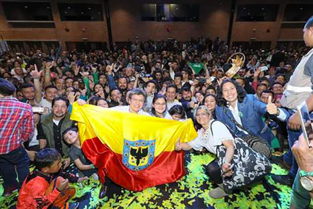 Claudia López celebrates in the centre of thousands of people.