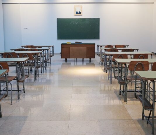 An empty classroom sums up Colombia's educational system. Photo by Ivan Aleksic on Unsplash.