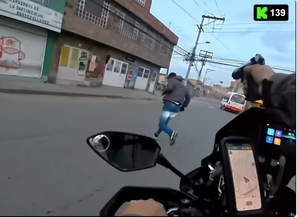Screenshot from Youtube video of private security guard opening fire on suspect car thief in downtown Bogotá. Vigilante firms are increasingly acting as law enforcement, often at risk to the public